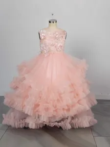 Detail of pink flower girl dress featuring sequined bodice and tiered mesh skirt