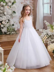 Detailed view of the elegant pearl trim and layered tulle mesh on white flower girl dress