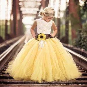 Detailed view of yellow tulle skirt with sunflower decoration and lace bodice for girls