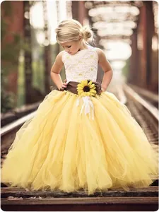 Detail of white lace bodice and yellow tutu skirt with sunflower waist decoration