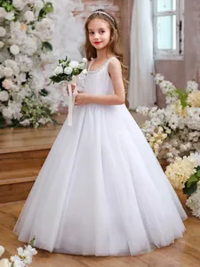 Detail of white sparkling tulle girls party dress with pearl trim and sequin bodice