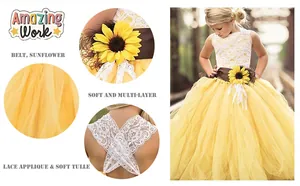 Detail of white lace bodice with cross-back straps and sunflower belt on flower girl dress