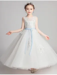 Detail of white flower girl dress featuring light blue floral embroidery and waist ribbon