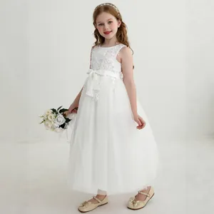Detail of elegant white lace embroidery and layered tulle on girls princess dress