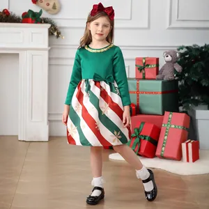 Detail of Christmas dress with dark green satin bodice and red striped snowflake skirt