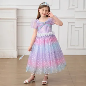 Detail of girls mermaid princess dress with silver scale texture and sequined shell bodice