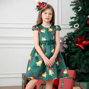 Detail of dark green Christmas dress with golden bells and festive holiday prints