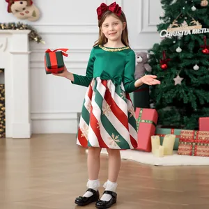 Detail of girls Christmas dress with green satin bodice and striped candy cane skirt