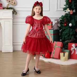 Close-up of red sequin princess dress with puff sleeves and bow detail for girls