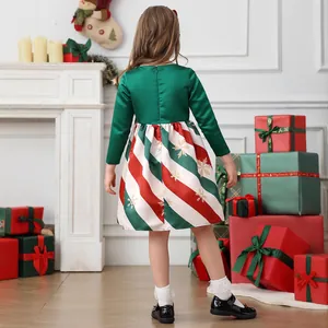 Detail view of girls Christmas dress showing green satin back and colorful striped skirt