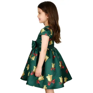 Detail of dark green satin Christmas dress with gold bell prints and big waist bow