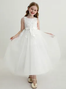 Elegant sleeveless white lace flower girl dress with layered tulle and bow for birthday