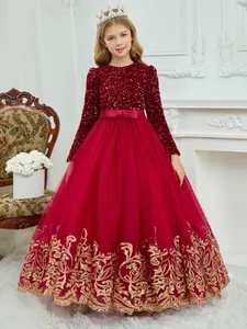 Detailed close-up of dark red sequined bodice and golden lace embroidery on girls dress