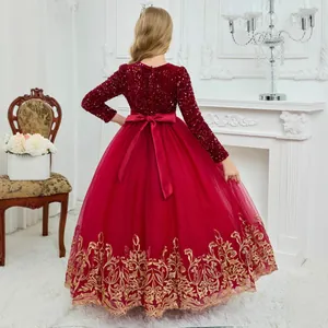 Detail of red girls gown with sequins, large satin back bow and gold embroidery