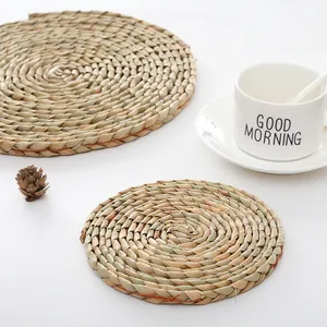 Detail of round hand-woven straw heat-resistant placemats with a rustic Japanese style