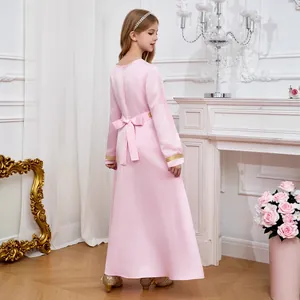 Detailed back view of pink Arab girl dress featuring a large bow and gold lace embroidery