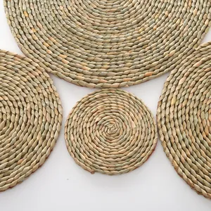 Detail showing natural handwoven straw placemats in multiple sizes with spiral textures