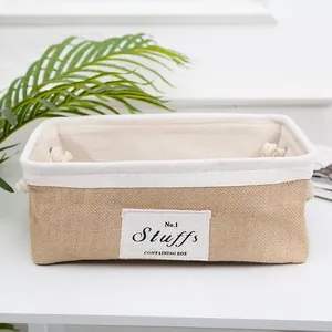 Detail of jute storage basket with cotton lining and rope handle on a clean background