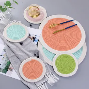 Detailed top view of round woven cotton placemats and coasters in macaron color palette