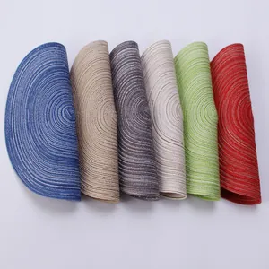 Handwoven round ramie placemats in six colors including blue and gold on white background