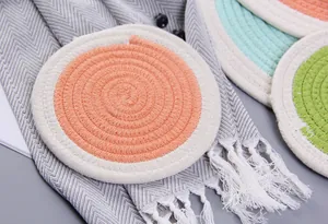 Detail of round cotton braided placemat with dual-tone spiral weave and thick insulation