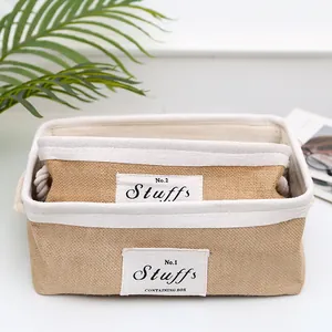 Detail view of jute storage baskets with side rope handles and fabric edging labels