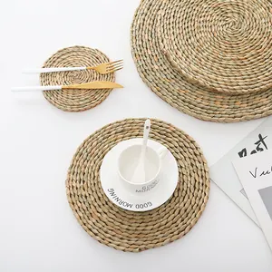 Macro view of natural woven straw placemats and coasters with thick spiral texture