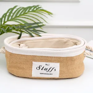 Detail of woven jute storage basket showing cotton rope handle and fabric label