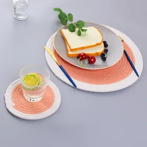 Detail of pink and beige woven cotton placemat set showing spiral braided texture