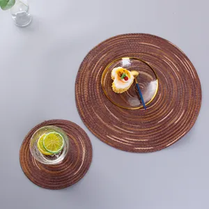 Detailed top view of handmade round woven placemats in a Nordic minimalist dining scene