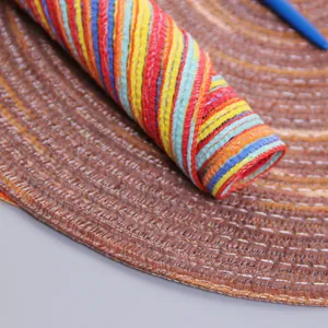 Macro shot of colorful woven linen placemat showing flexible texture and vibrant fiber patterns