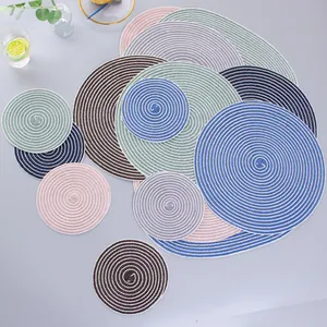 Macro shot of colorful woven spiral placemats and coasters set in diverse sizes