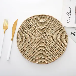 Detail of round woven rush heat-resistant placemat with natural texture and spiral pattern