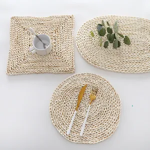 Handcrafted corn husk table mat set in round, oval, and square shapes on white background