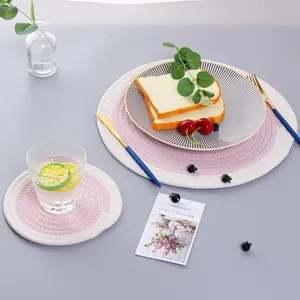 Close-up of pink and beige woven cotton placemats in a Nordic dining setting