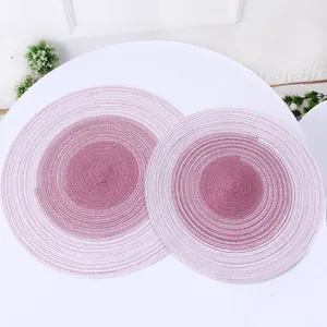 Macro detail of round braided ramie placemats with pink gradient spiral texture