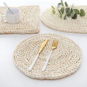 Minimalist corn husk woven placemats in round, rectangle, and oval shapes for home decor