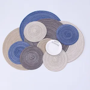 Detail of multi-size round woven placemats in blue and grey with spiral texture