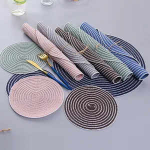 Close-up of circular woven cotton placemats and coasters with spiral texture