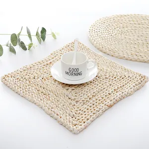 Macro detail of natural hand-woven corn husk placemat with thick heat resistant texture