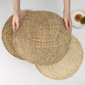 Macro shot showing texture of woven round seagrass placemats in natural plant fibers