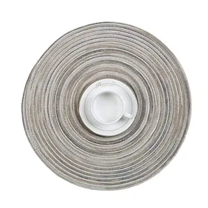 Macro detail of round woven ramie coaster with beige and grey spiral texture