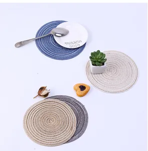 Detail of woven round placemats with spiral texture in blue, beige, and dark grey tones