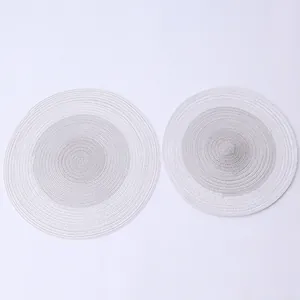 Macro detail of Nordic gradient round woven placemats with spiral cotton rope texture