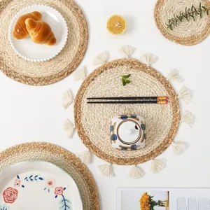 Close-up of handmade woven heat-resistant mats and coasters in natural straw and beige