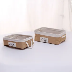 Detail of two-piece jute storage baskets with cotton rope handles and fabric lining
