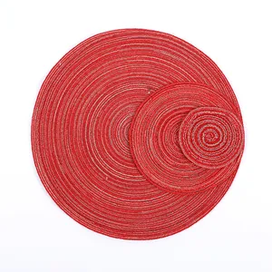 Detail of red and silver round woven placemats in three nested sizes for dining decor