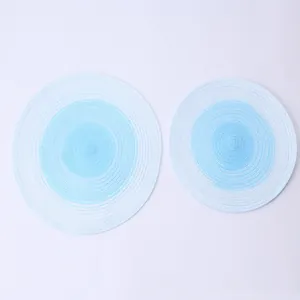 Close-up of blue and white gradient woven ramie placemats in large and small sizes