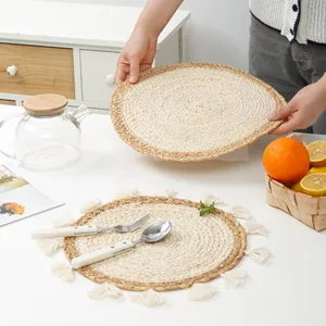 Handwoven round corn husk placemats with tassel detail for minimalist table decor