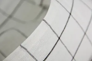 Macro di tovaglietta in cotone nordico con trama a quadri neri e cuciture dettagliate